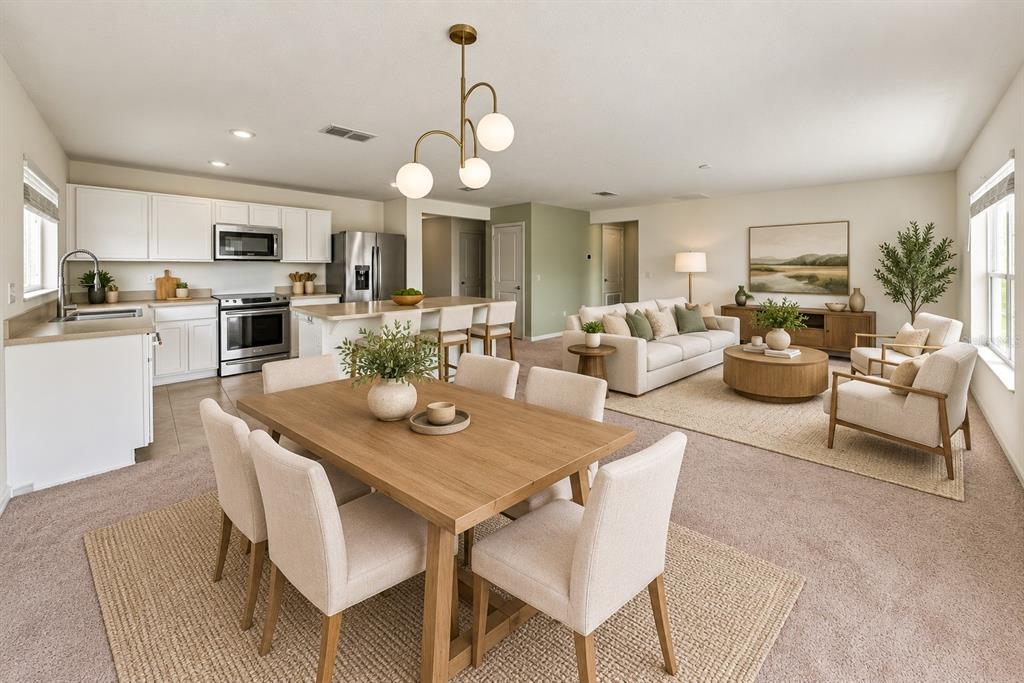 A kitchen with white cabinets, stainless steel appliances, and a central island with a countertop — 1444 MATTIE POINTE LANE, AUBURNDALE, FL