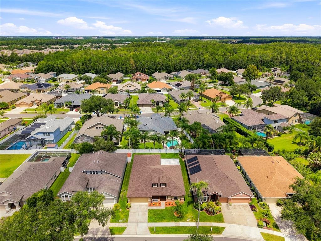 A single-story suburban house features a two-car garage, dormer windows, and a front porch — 30501 IVERSON DRIVE, WESLEY CHAPEL, FL
