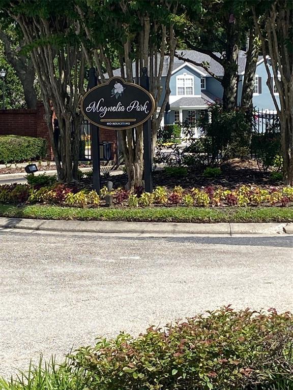 A sign for Magnolia Park stands in front of a blue house and trees — 2130 PINE OAK TRAIL, SANFORD, FL