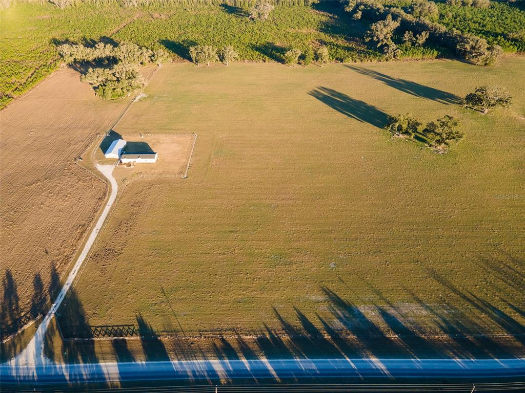 An aerial view shows a house and barn on a large, fenced rural property — 004 NW 202ND STREET, NEWBERRY, FL