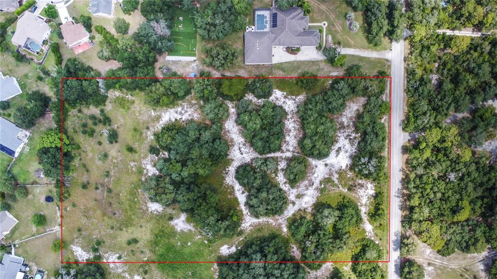An aerial view shows a rectangular plot of land with trees and sandy patches — 1156 HIGHLAND ACRES DRIVE, APOPKA, FL