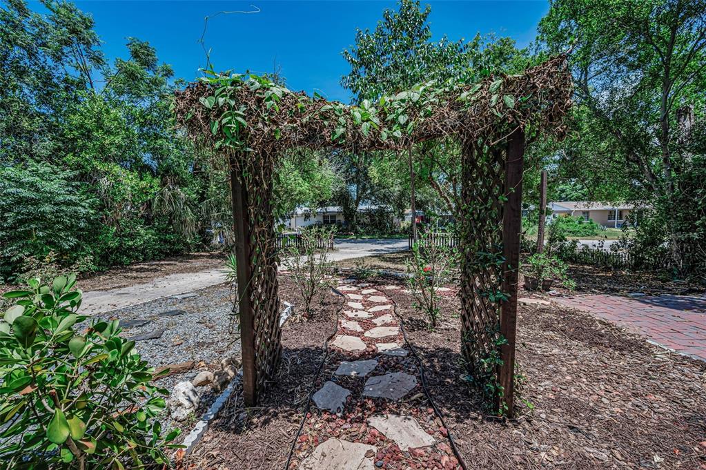 A single-story house with a stone walkway, a covered entryway, and an attached garage — 4312 BEACON SQUARE DRIVE, HOLIDAY, FL