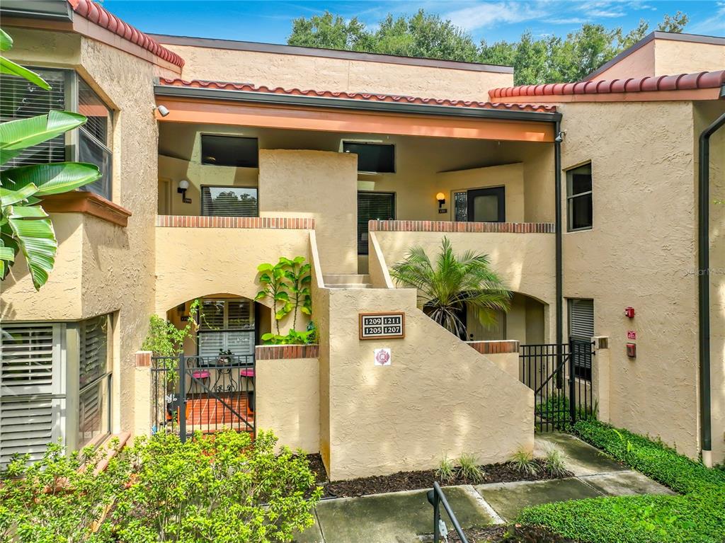 A front door with a glass storm door, a welcome sign, and a welcome mat — 1211 SALERNO COURT UNIT 1211, ORLANDO, FL