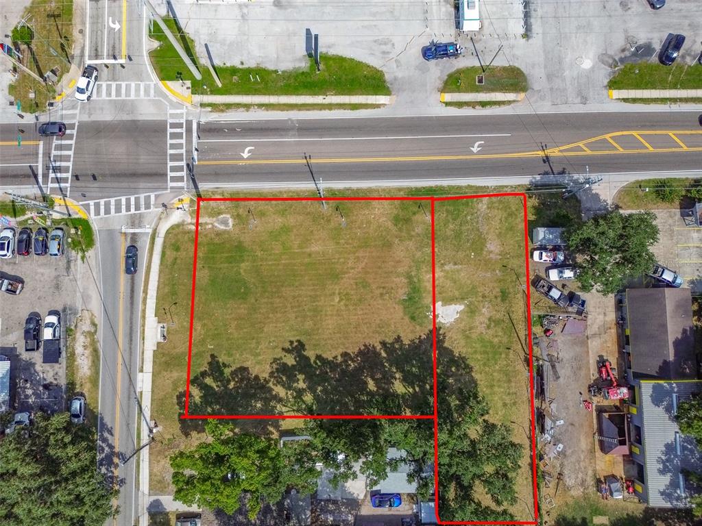 An aerial view shows a vacant, rectangular lot outlined in red next to a paved road — 1336 N COMBEE ROAD, LAKELAND, FL