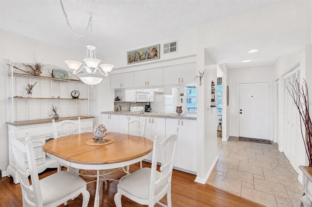 A balcony with a grill, patio furniture, and a view of a lake — 6475 SHORELINE DRIVE UNIT 5102, ST PETERSBURG, FL