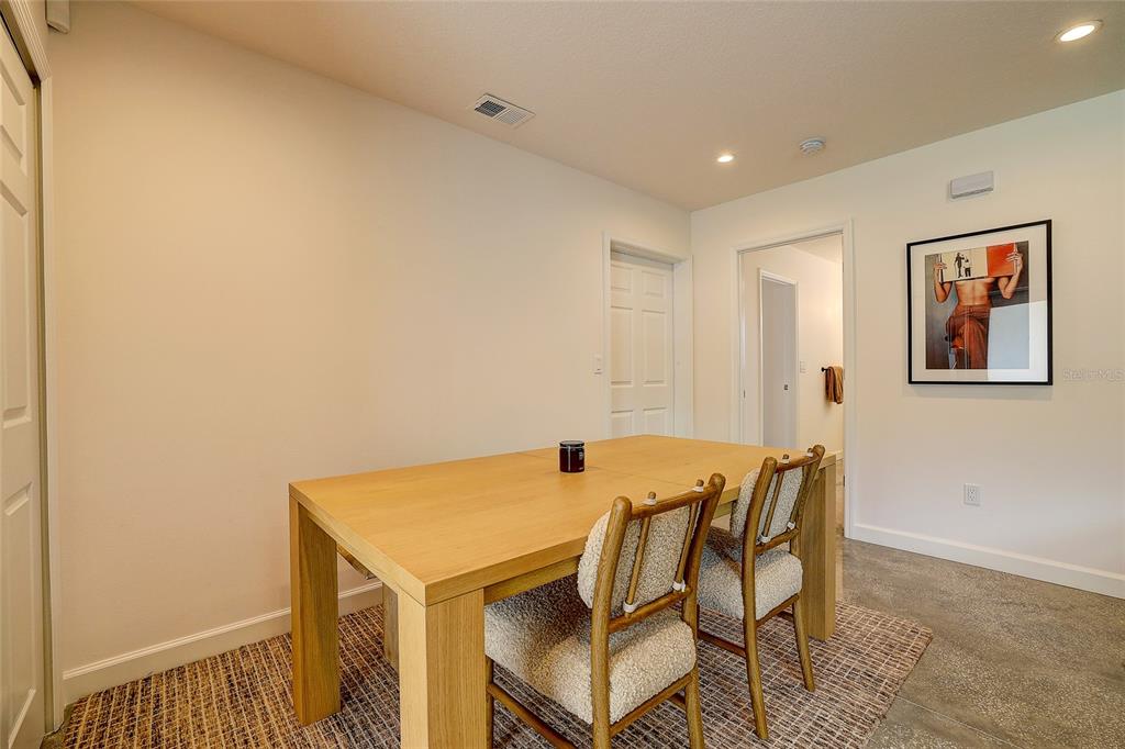 A dining area features a light wood table, upholstered chairs, and a framed wall print — 2121 PALM TERRACE, SARASOTA, FL