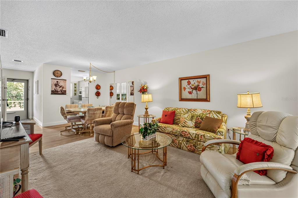 A kitchen features white cabinets, a white stove, a microwave, and a white refrigerator — 4801 AIRPORT ROAD UNIT 119, ZEPHYRHILLS, FL