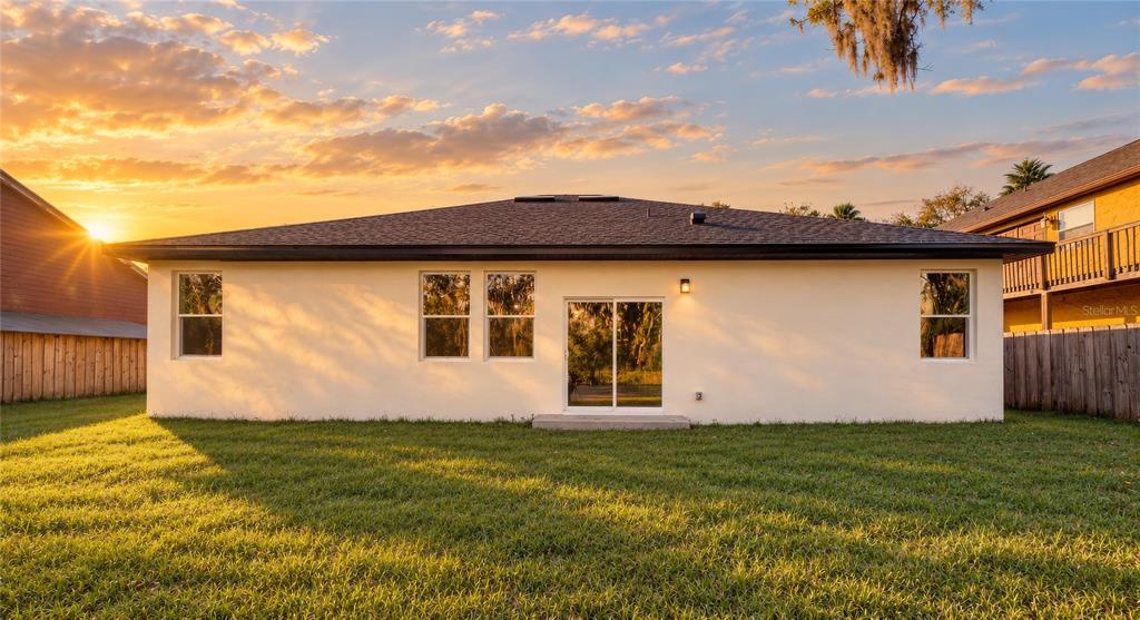 The exterior entrance features a black front door, a concrete porch, and a white pillar — 127 HIBISCUS LANE, DELTONA, FL