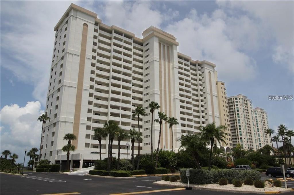 An aerial view of a beach, a swimming pool, and a tennis court — 1230 GULF BOULEVARD UNIT 306, CLEARWATER BEACH, FL