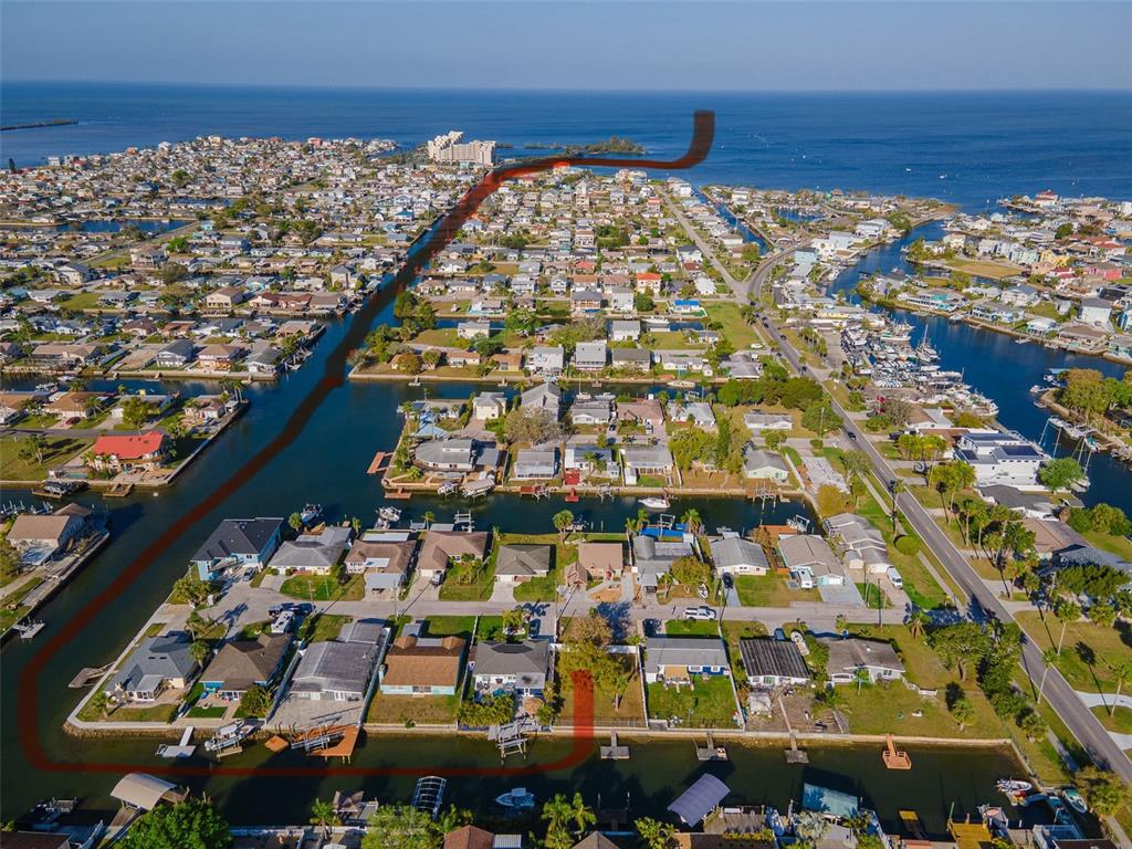 An aerial view of a waterfront residential neighborhood with a red outline highlighting a property — 13916 BERKOWITZ AVENUE, HUDSON, FL
