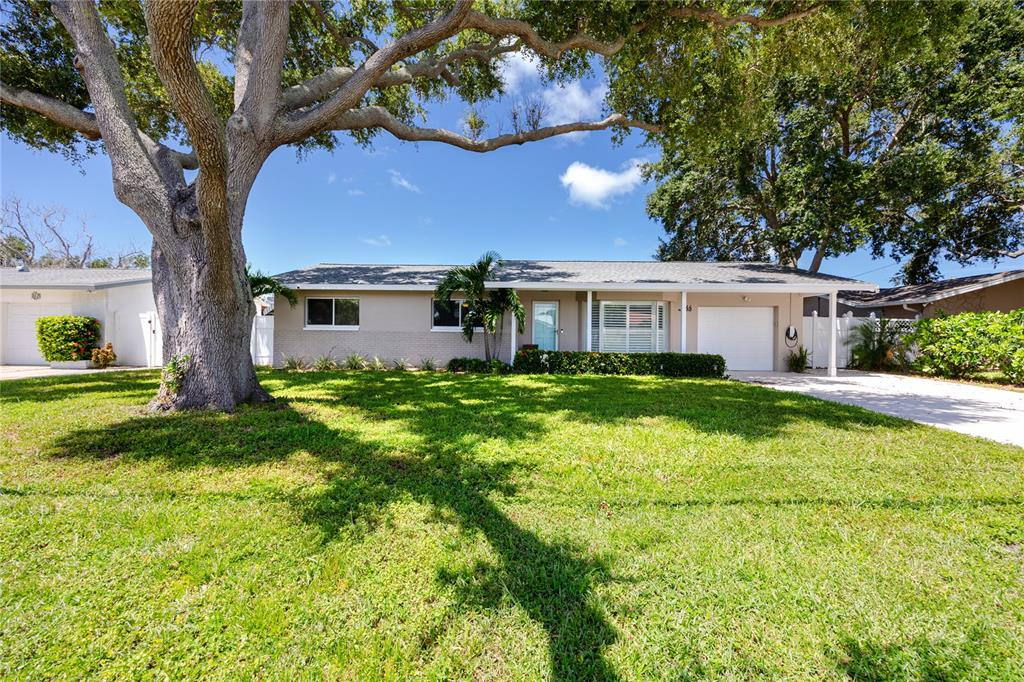 A single-story house with a large oak tree in the front yard — 1744 HARBOR CIRCLE E, LARGO, FL