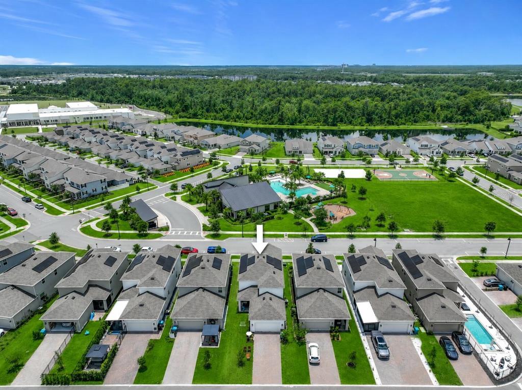 An aerial view shows a row of suburban houses with solar panels and a community pool — 11835 BOLDFACE DRIVE, ORLANDO, FL