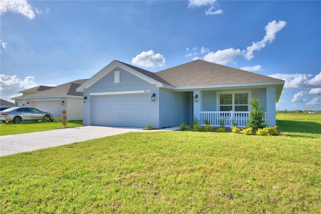 A light blue single-story house with a two-car garage and a front porch — 3636 LINDBERGH STREET, LAKELAND, FL