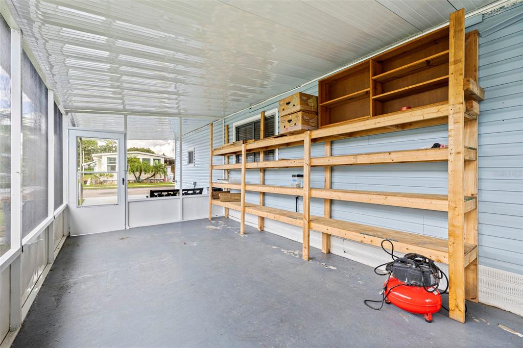 A blue mobile home with a carport and a Jeep parked in the driveway — 6100 62ND AVENUE N UNIT 38, PINELLAS PARK, FL