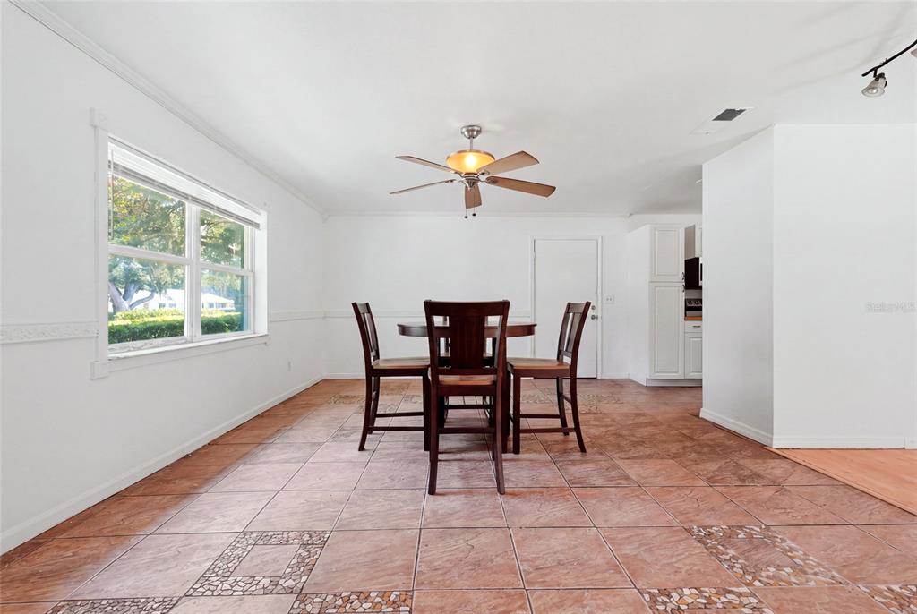 A white house with a black front door, blue shutters, and a concrete walkway — 3145 NW 48TH PLACE, GAINESVILLE, FL