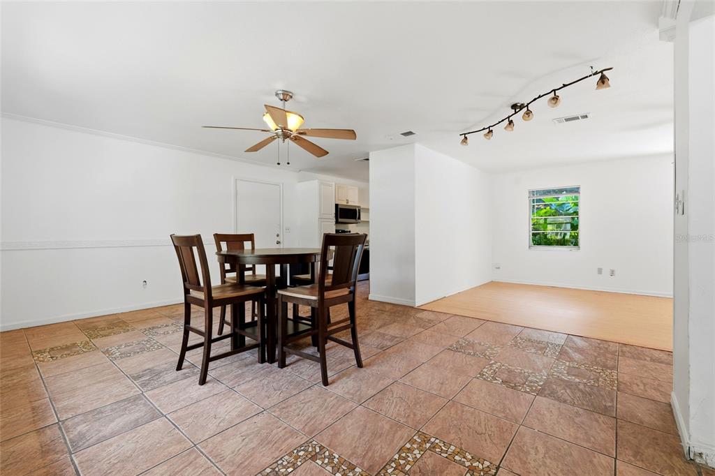 A dining area with a table and chairs features tiled floors and a ceiling fan — 3145 NW 48TH PLACE, GAINESVILLE, FL
