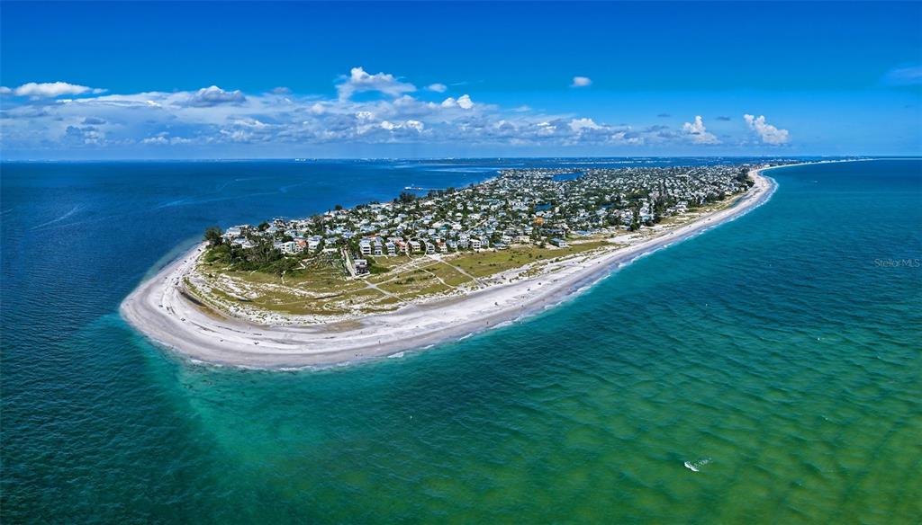 An aerial view of a coastal neighborhood with houses situated near a sandy beach — 801 N SHORE DRIVE, ANNA MARIA, FL