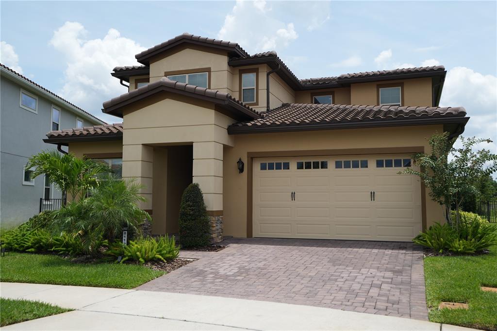 A two-story house with a backyard pool and a covered patio area — 8112 CLEOBURY DRIVE, ORLANDO, FL