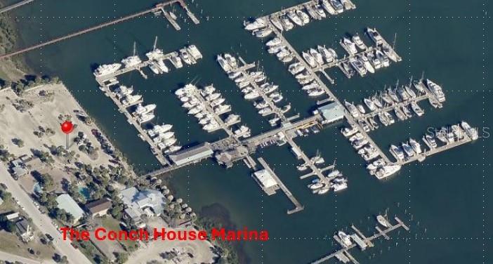 An aerial view shows a marina with numerous boat slips and a nearby parking area — 57 COMARES AVENUE UNIT D-4, ST AUGUSTINE, FL