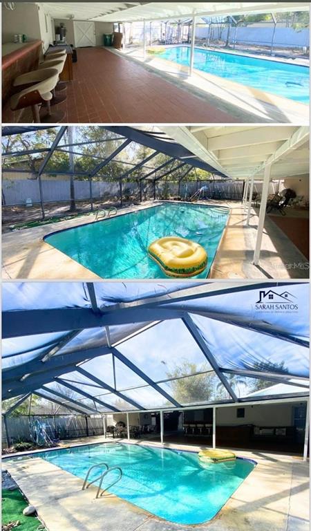 A swimming pool with a screen enclosure and an adjacent covered patio with bar seating — 1509 TATE STREET, COCOA, FL