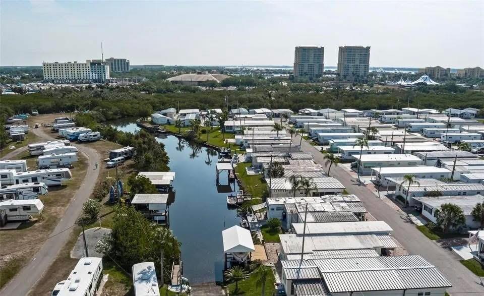 An aerial view shows a canal running through a mobile home park near city buildings — 9 TENNESSEE STREET, PALMETTO, FL