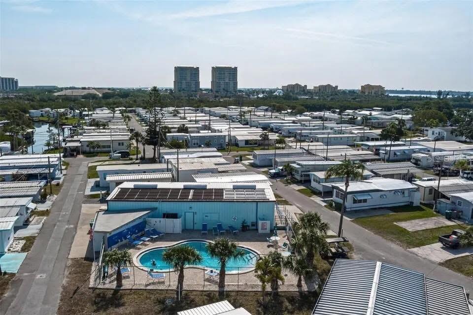 An aerial view shows a community of mobile homes with a central swimming pool area — 9 TENNESSEE STREET, PALMETTO, FL