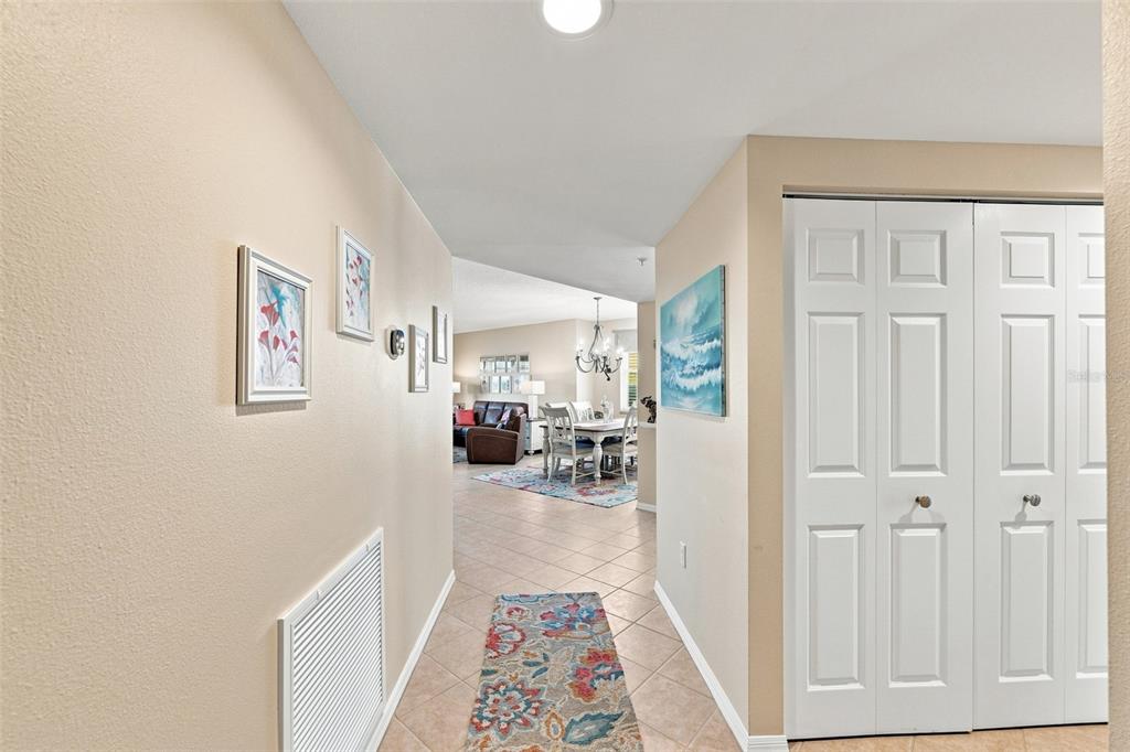 A hallway with tile flooring leads into a living and dining area with light walls — 6450 SHORELINE DRIVE UNIT 9306, SEMINOLE, FL