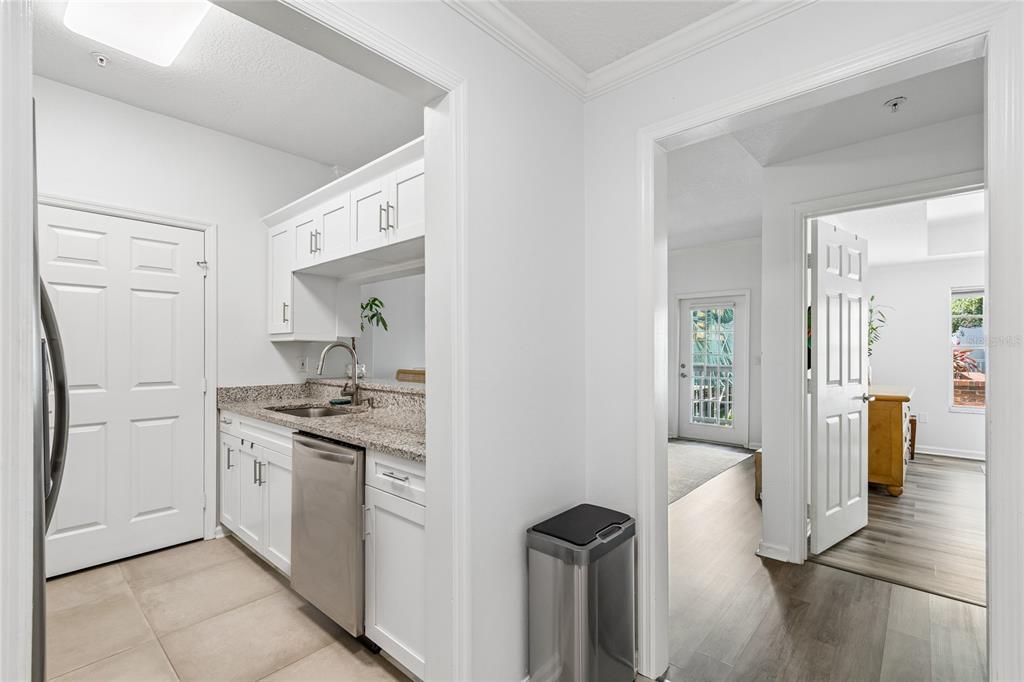 A kitchen features stainless steel appliances, white cabinetry, and granite countertops — 800 S DAKOTA AVENUE UNIT 237, TAMPA, FL