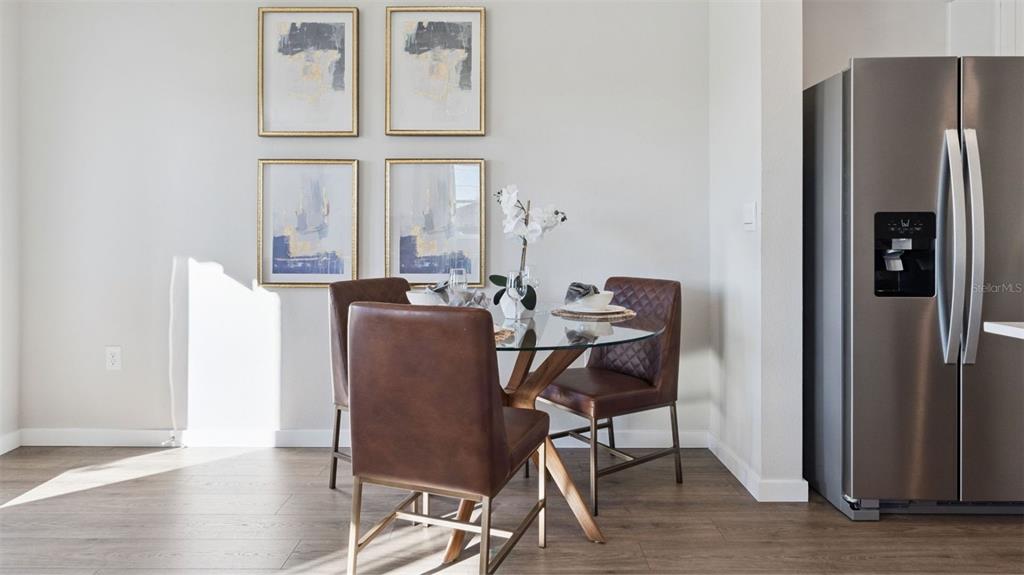 A dining area features a glass-topped table, brown leather chairs, and four framed wall prints — 600 PRESTON COVE DRIVE, ST CLOUD, FL