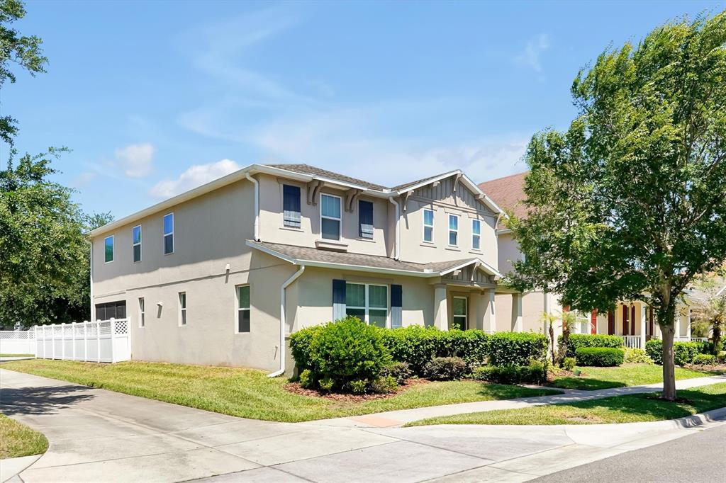 An aerial view shows a suburban neighborhood with houses, a lake, and green trees — 7922 WINTER WREN STREET, WINTER GARDEN, FL