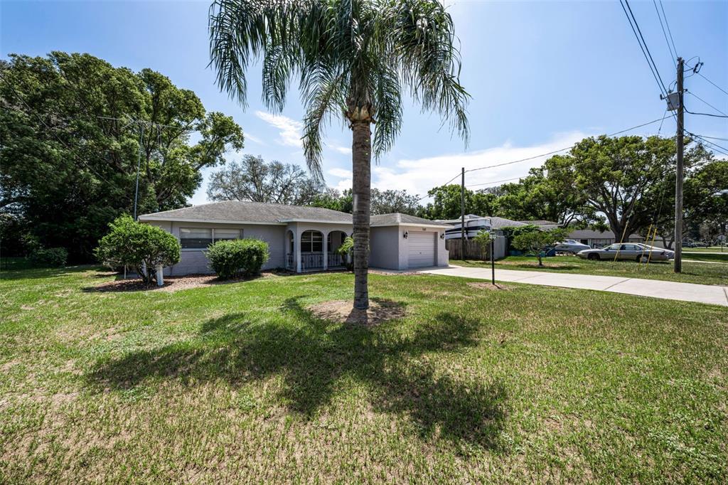 A single-story house with a gray exterior, a front porch, and an attached garage — 362 PORTLAND AVENUE, SPRING HILL, FL