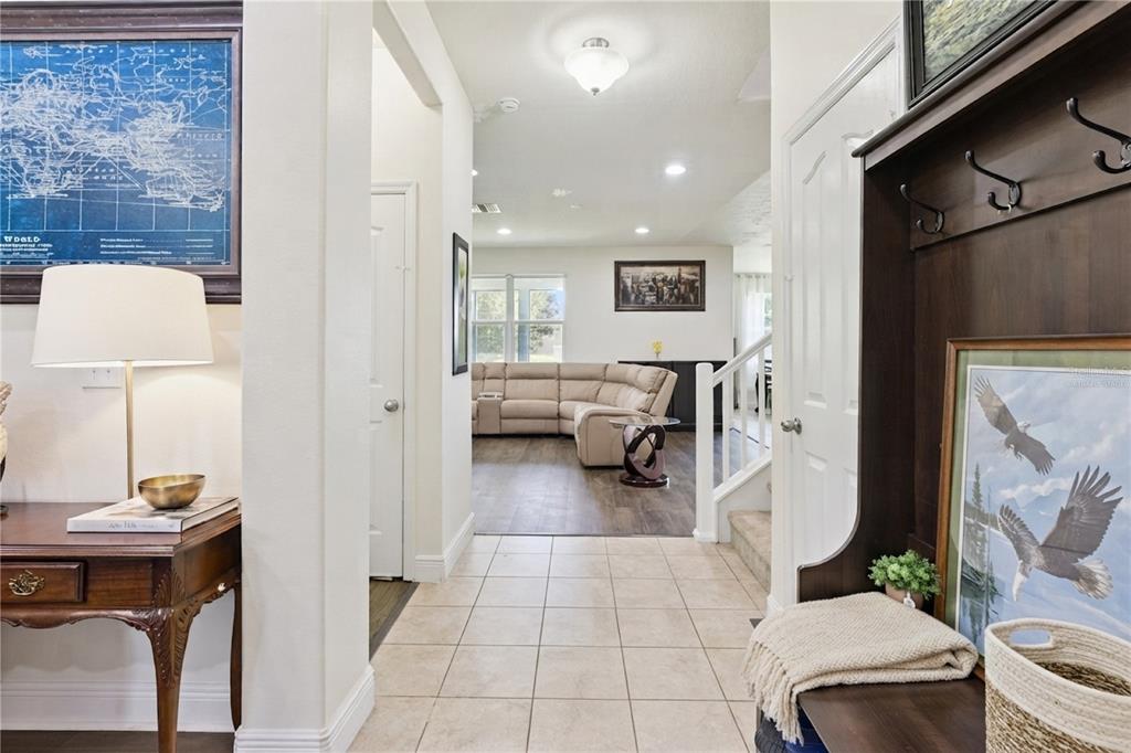 A tiled entryway leads into a living room featuring a large sectional sofa — 3254 LANDING VIEW, TAVARES, FL