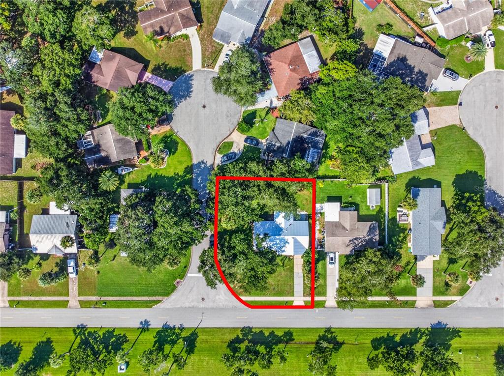 An aerial view shows a residential property highlighted in red within a suburban neighborhood — 5464 RIVERSIDE DRIVE, PORT ORANGE, FL