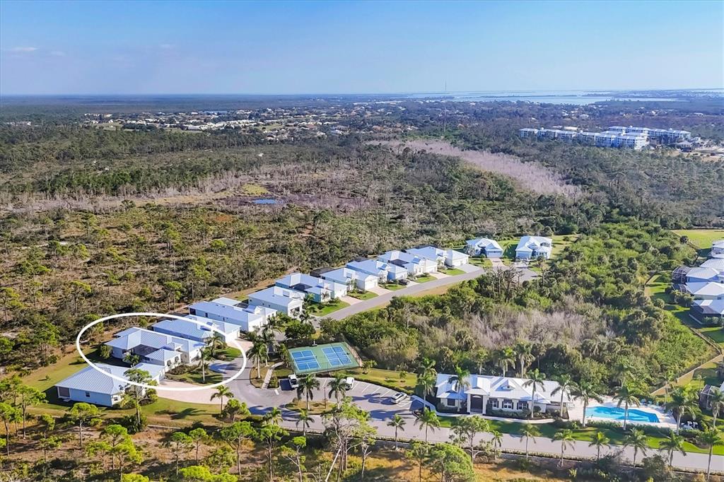 An aerial view shows a residential neighborhood with a circled house and tennis courts — 8920 CONCH AVENUE, PLACIDA, FL