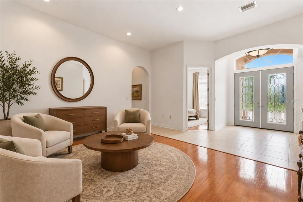 A dining room with hardwood floors, a wooden table, three chairs, and a chandelier — 5021 CHAMPIONSHIP CUP LANE, SPRING HILL, FL
