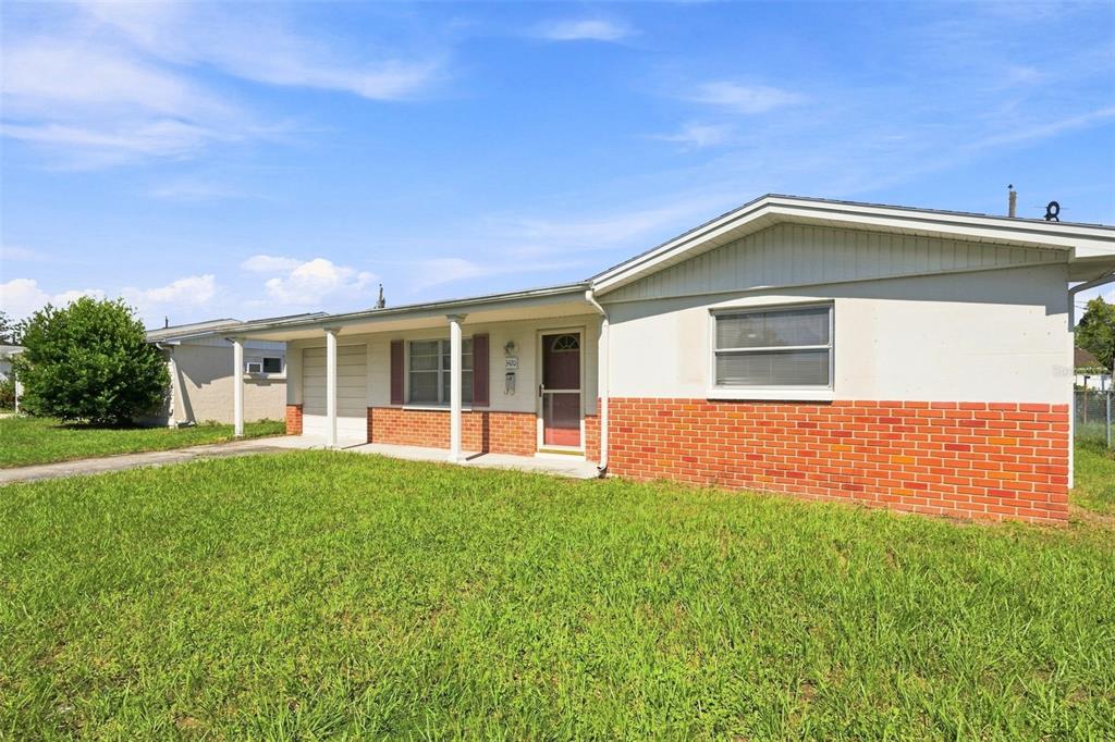 A single-story house with a brick and light-colored facade, a front porch, and a lawn — 3420 BLAYTON STREET, HOLIDAY, FL