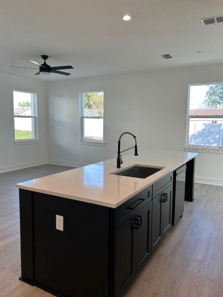 A kitchen island with a black base and white countertop sits in a room with light flooring — 2051 PEEL AVENUE, ORLANDO, FL