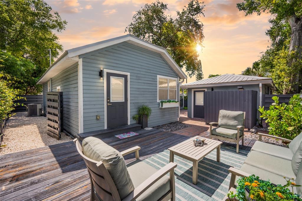 A small blue cottage with a wooden deck, outdoor seating, and a separate detached structure — 1841 LAUREL STREET, SARASOTA, FL