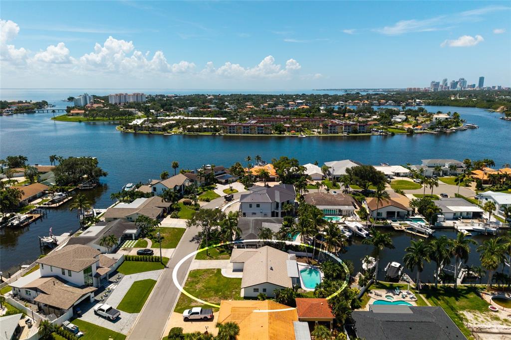An aerial view shows a waterfront house with a pool, dock, and surrounding residential neighborhood — 3960 13TH WAY NE, ST PETERSBURG, FL