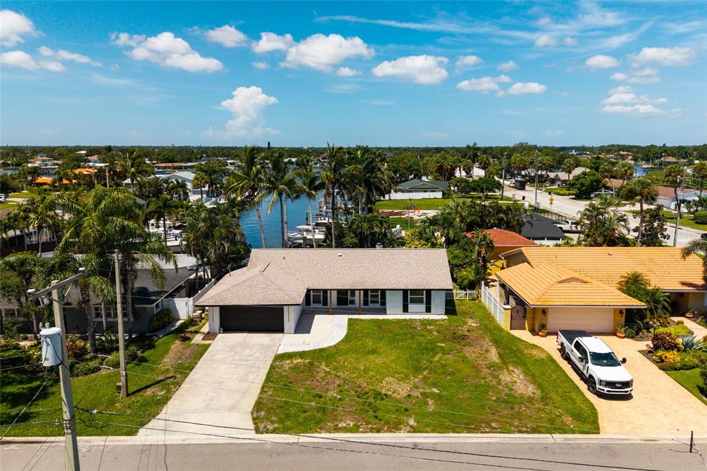 An aerial view shows a single-story house with a concrete driveway and a grassy yard — 3960 13TH WAY NE, ST PETERSBURG, FL