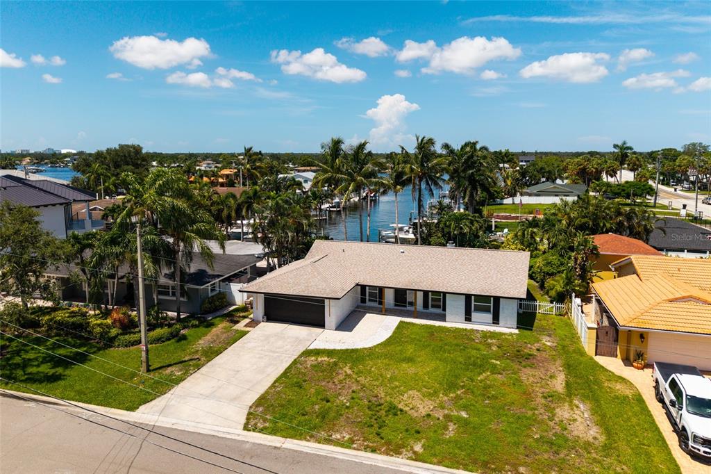 An aerial view of a single-story house with a garage and a canal in back — 3960 13TH WAY NE, ST PETERSBURG, FL