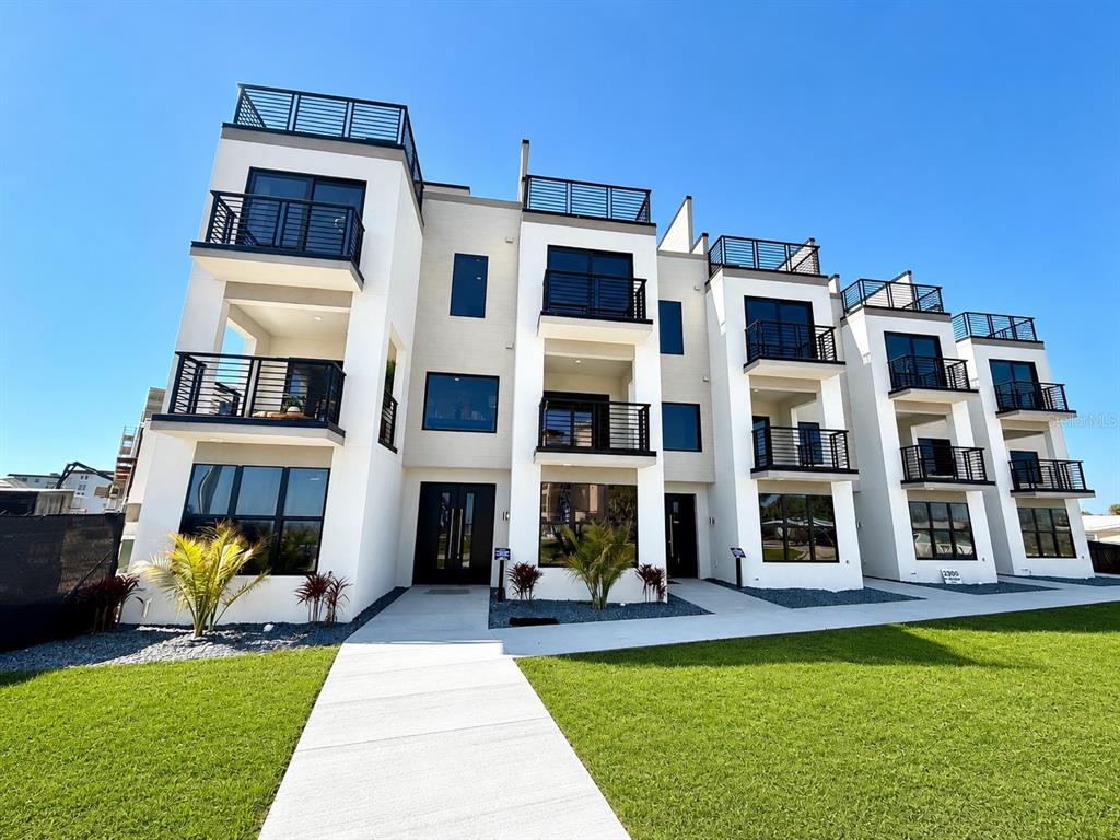 This is a rendering of a modern apartment complex with a pool and rooftop terraces — 2360 OCEAN SHORE BOULEVARD UNIT 403, ORMOND BEACH, FL