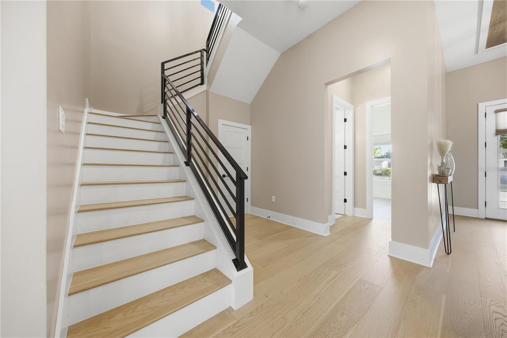 A modern white house exterior features a double front door, stone accents, and paved driveway — 4022 W BAY TO BAY BOULEVARD, TAMPA, FL
