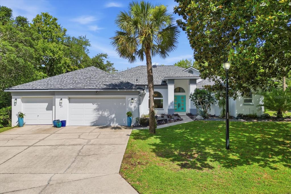 An aerial view shows a house with a screened pool surrounded by dense green trees — 21 FIDDLEWOOD COURT, HOMOSASSA, FL