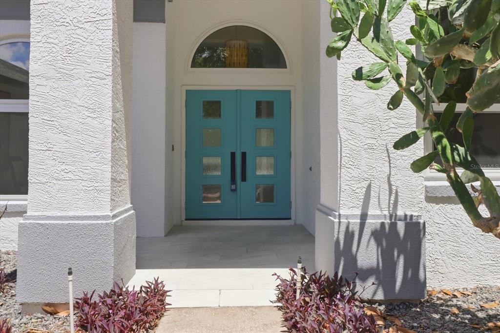 A single-story house with a white exterior, a gray roof, and a landscaped front yard — 21 FIDDLEWOOD COURT, HOMOSASSA, FL