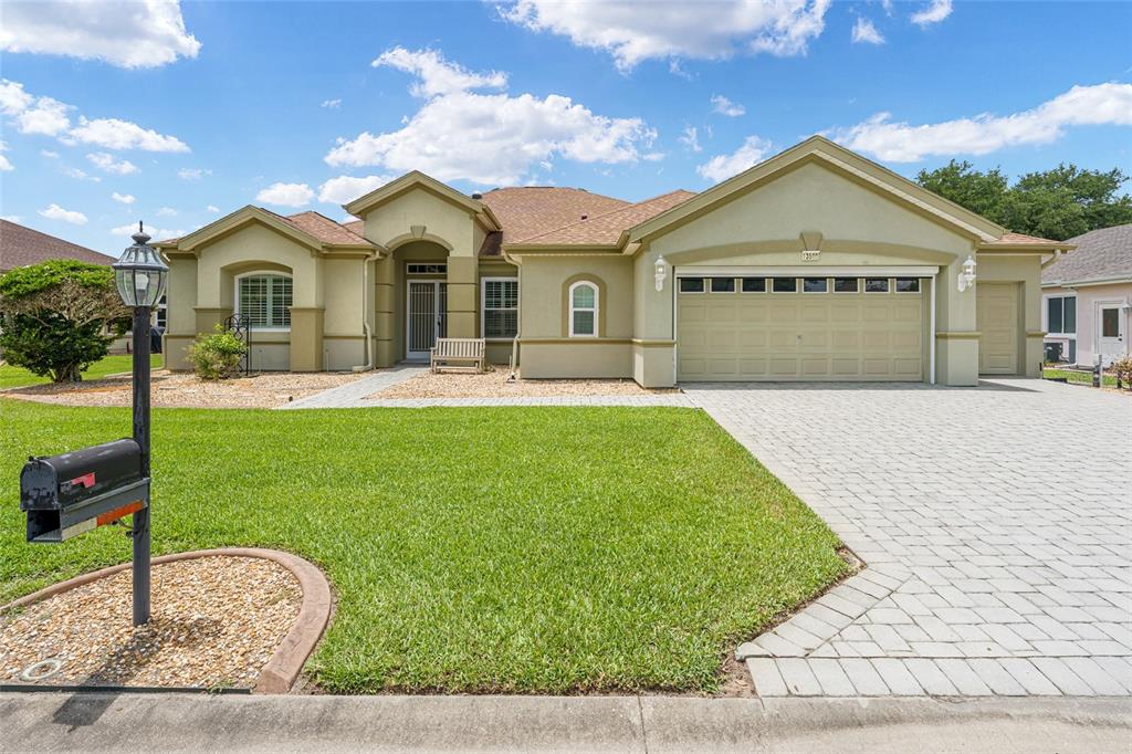 The exterior of a light green house with a brown shingled roof and lawn — 13500 SE 97TH TERRACE ROAD, SUMMERFIELD, FL