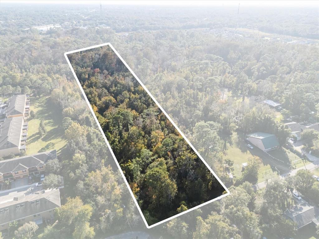 An aerial view shows a rectangular, wooded plot of land outlined in white — HILL TOP DRIVE, LAKE MARY, FL
