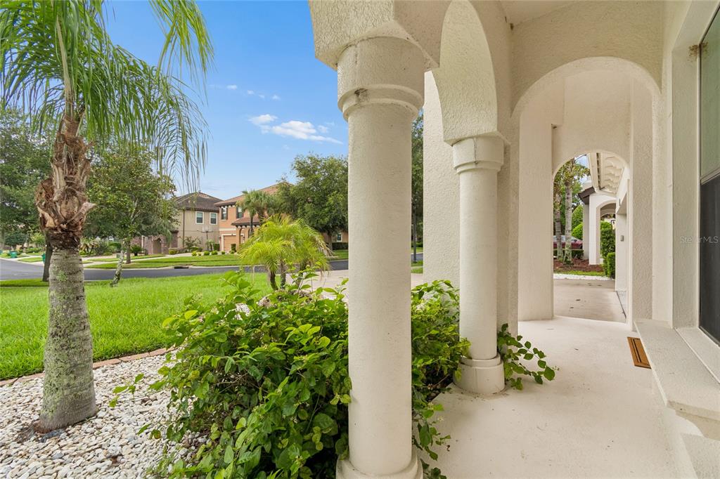 A two-story Mediterranean-style house with a tile roof, three-car garage, and a concrete driveway — 2719 CALVANO DRIVE, LAND O LAKES, FL