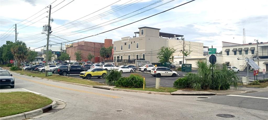 A parking lot sits in front of a multi-story building at a street intersection — 94 SW FT KING, OCALA, FL