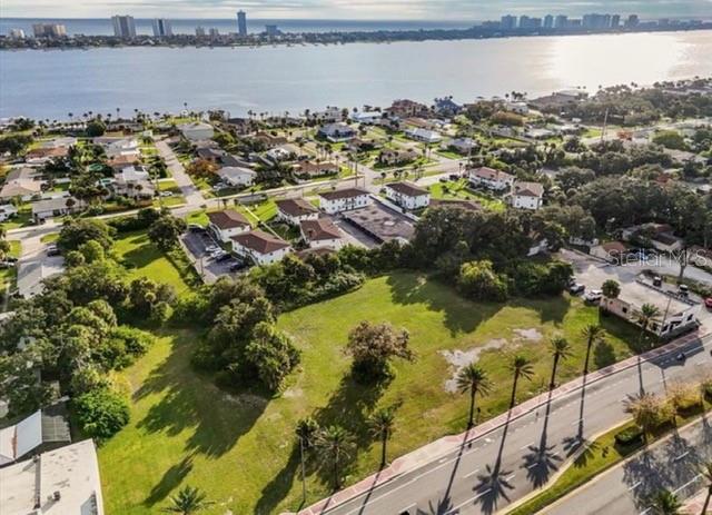 An aerial view shows a vacant grassy lot bordered by a road and nearby residential buildings — 1745 S RIDGEWOOD AVENUE, SOUTH DAYTONA, FL